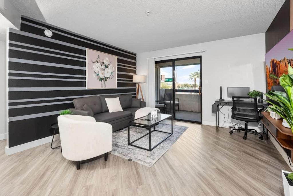 a living room with a black and white striped wall at Chill 2BR Near ASU, Pool, Grill, Parking,Pet Frndly in Tempe