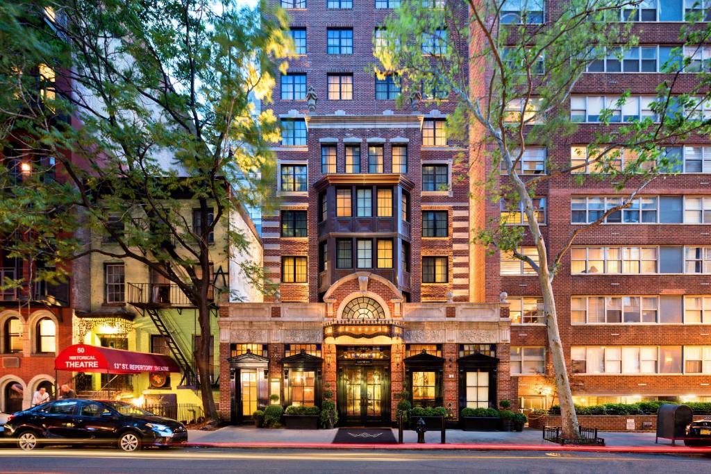 a building with a car parked in front of it at Walker Hotel Greenwich Village in New York