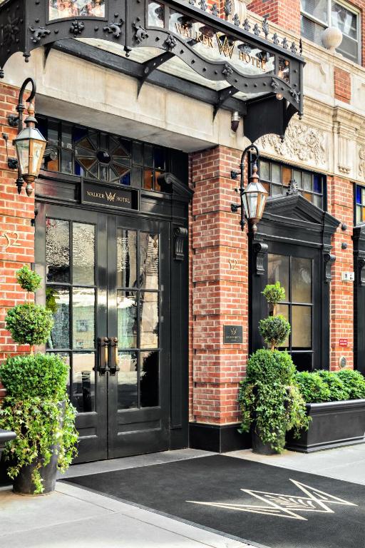 a store front with a black door on a brick building at Walker Hotel Greenwich Village in New York