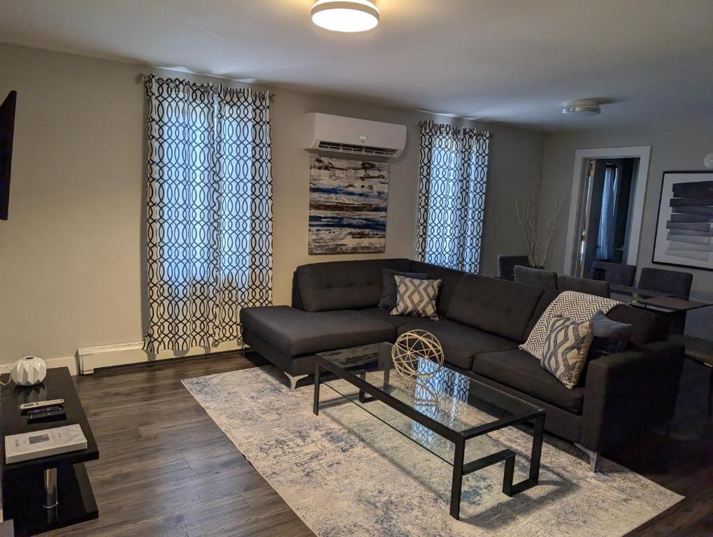 a living room with a couch and a coffee table at Clifton Hill Suite 2202 in Niagara Falls