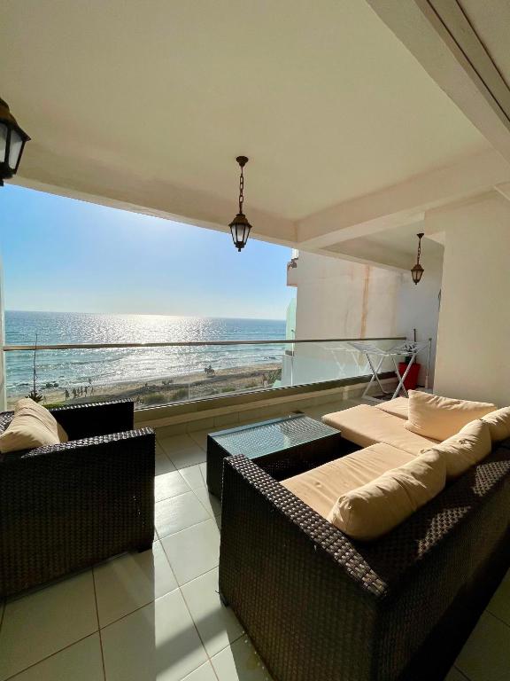 a room with two beds and a view of the ocean at Atlas Ocean View Vue Mer Directe in Aourir