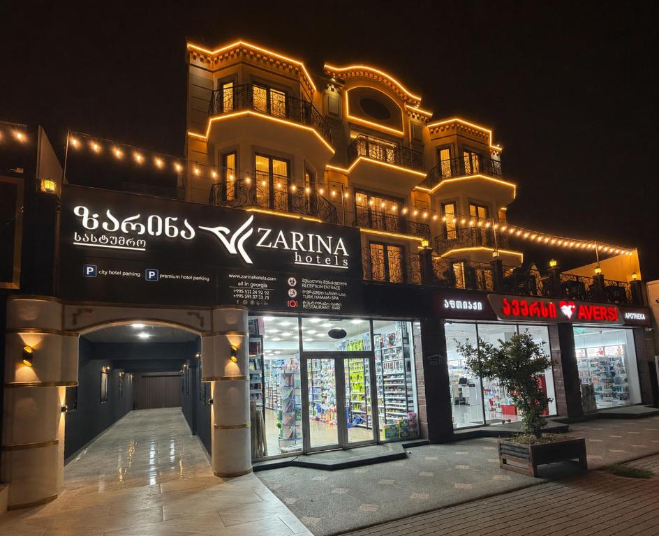 a building with lights on the side of it at Zarina Hotels & Hamam in Batumi
