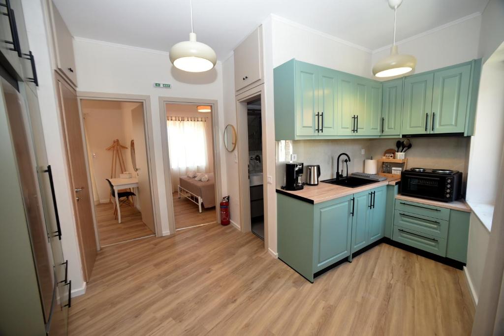 a kitchen with turquoise cabinets and a counter top at ANNA's House in Mythimna