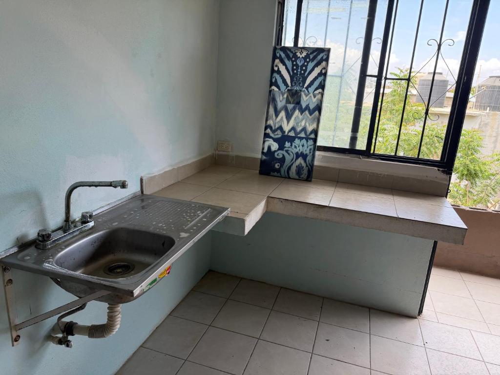 a sink in a room with a window and a window at HM cuarteria cangrejos in Cabo San Lucas