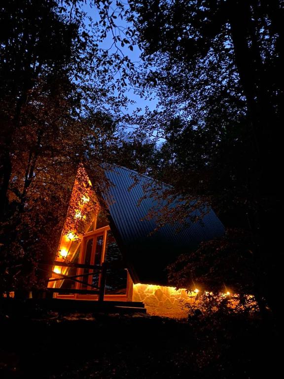 a small cabin with a porch at night at Mountain heaven in Andrijevica