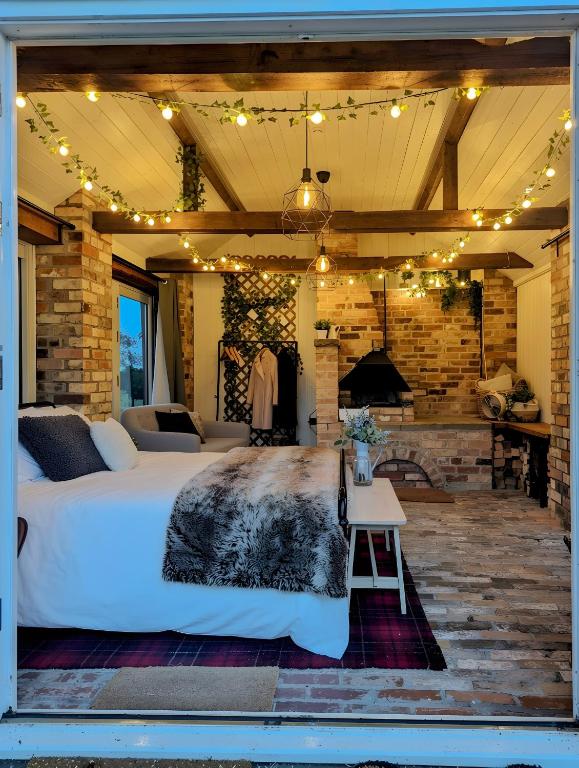 a bedroom with a large bed and a fireplace at The Old Forge in Bishop Wilton
