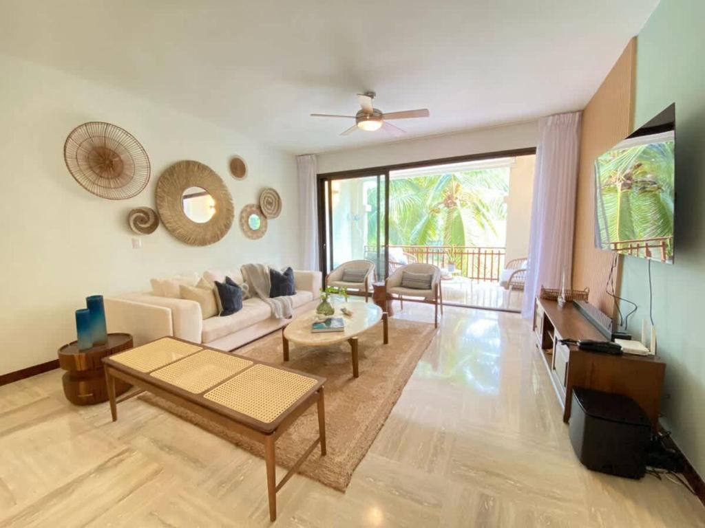 a living room with a couch and a table at Charming two-bedroom apartment in Las Terrenas in Las Terrenas