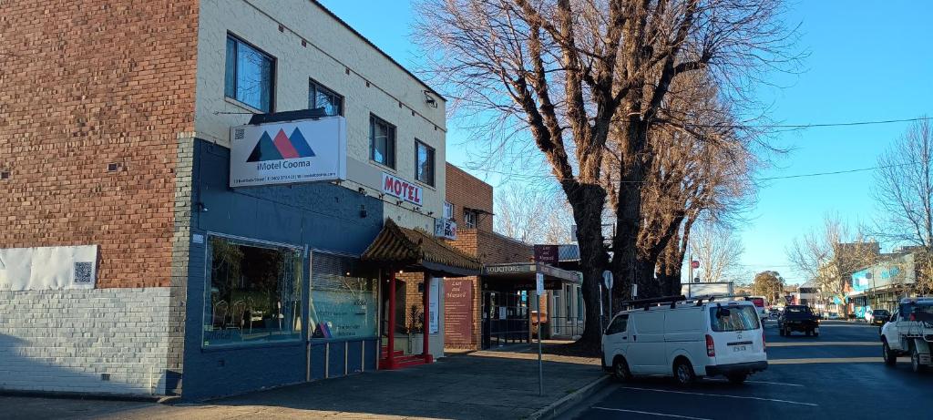 a white van parked in front of a brick building at iMotel Cooma in Cooma