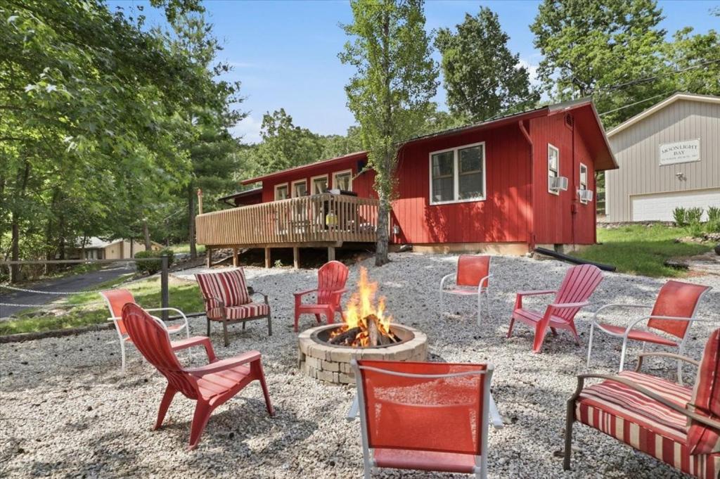 a fire pit in front of a tiny house at Private Dock, Boat Launch, Fire Pit & Lake Views in Sunrise Beach