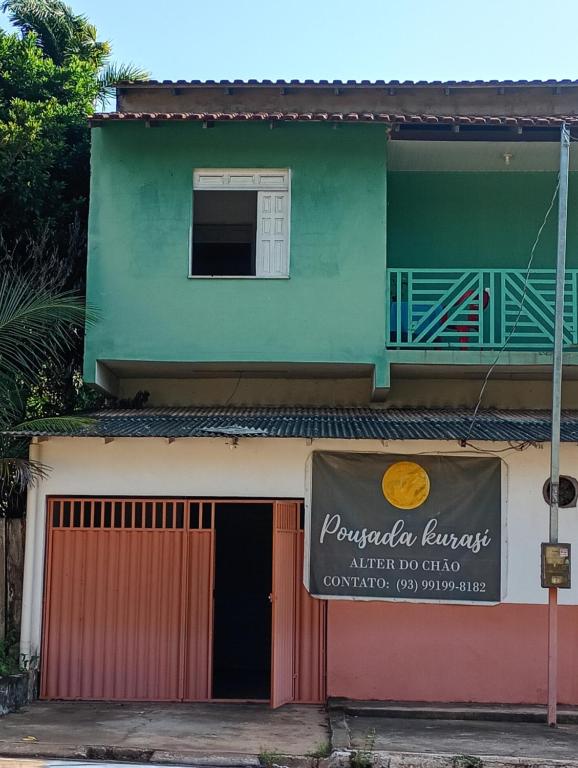 a building with a sign in front of it at Pousada kurasi alter 02 in Santarém