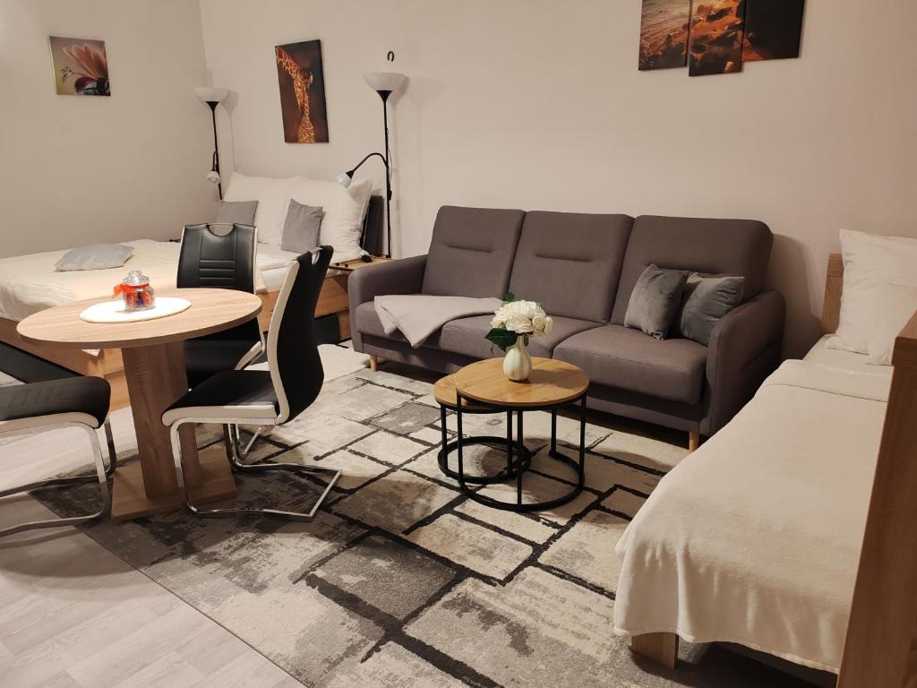 a living room with a couch and a table at Apartmán Nerudova in Česká Lípa