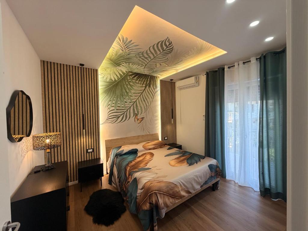 a bedroom with a bed with a painting on the wall at Lo Snodo Apartments cucina e parcheggio in Pomigliano dʼArco