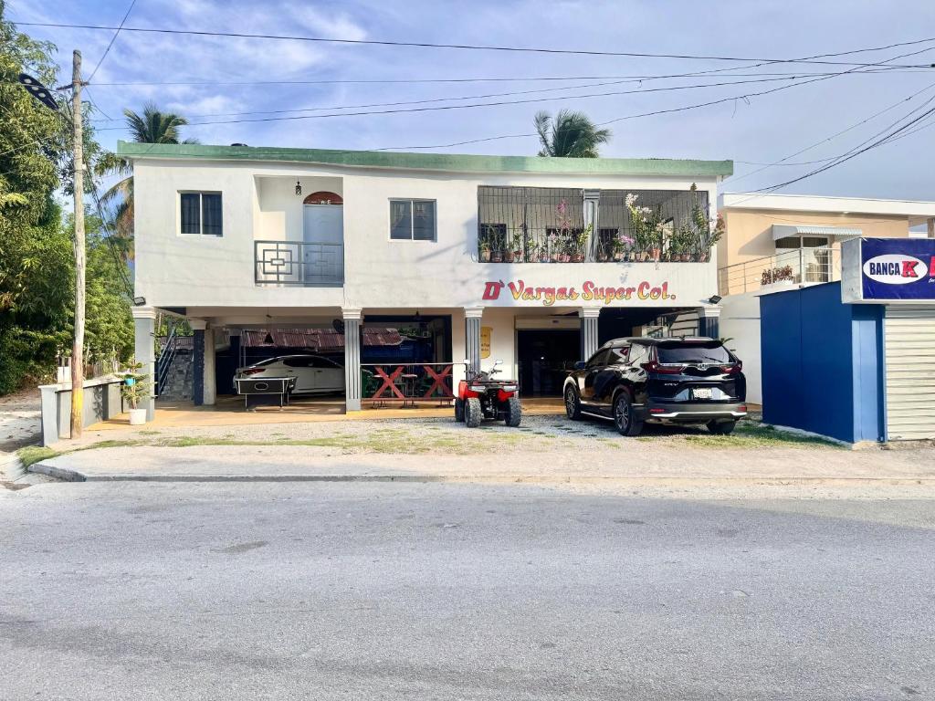 a house with a car parked in front of it at Alojamiento Wilkenia in Ochoa
