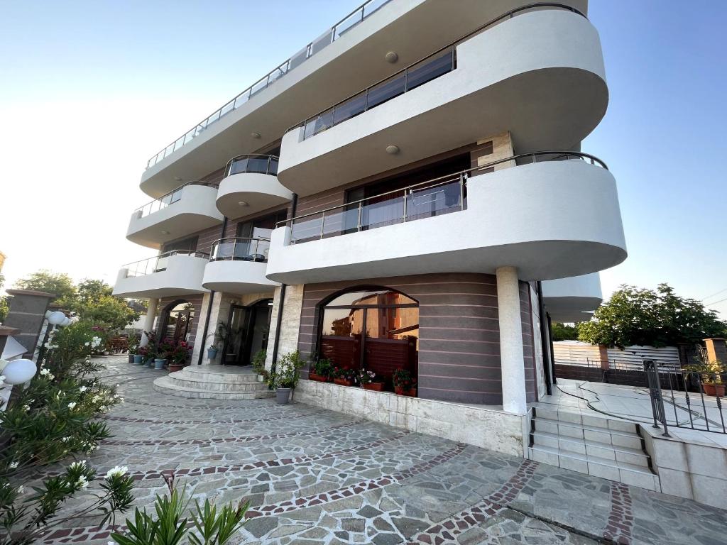a large building with a walkway in front of it at Silistar Hotel in Rezovo