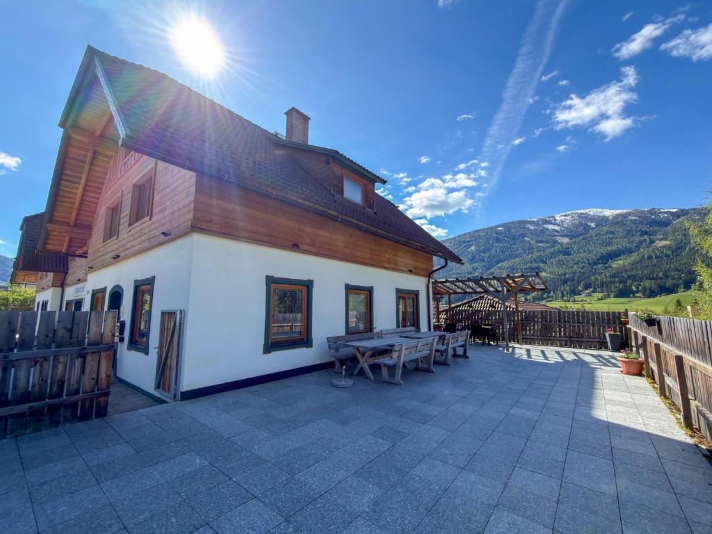 a building with a picnic table on a patio at Chalet-Apartment Alpenresidenz in Sankt Michael im Lungau