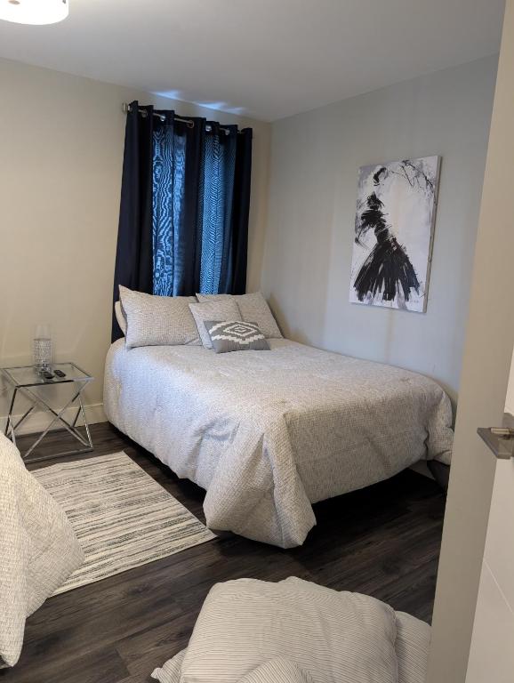 a bedroom with two beds and a window at Clifton Hill Suite 4401 in Niagara Falls