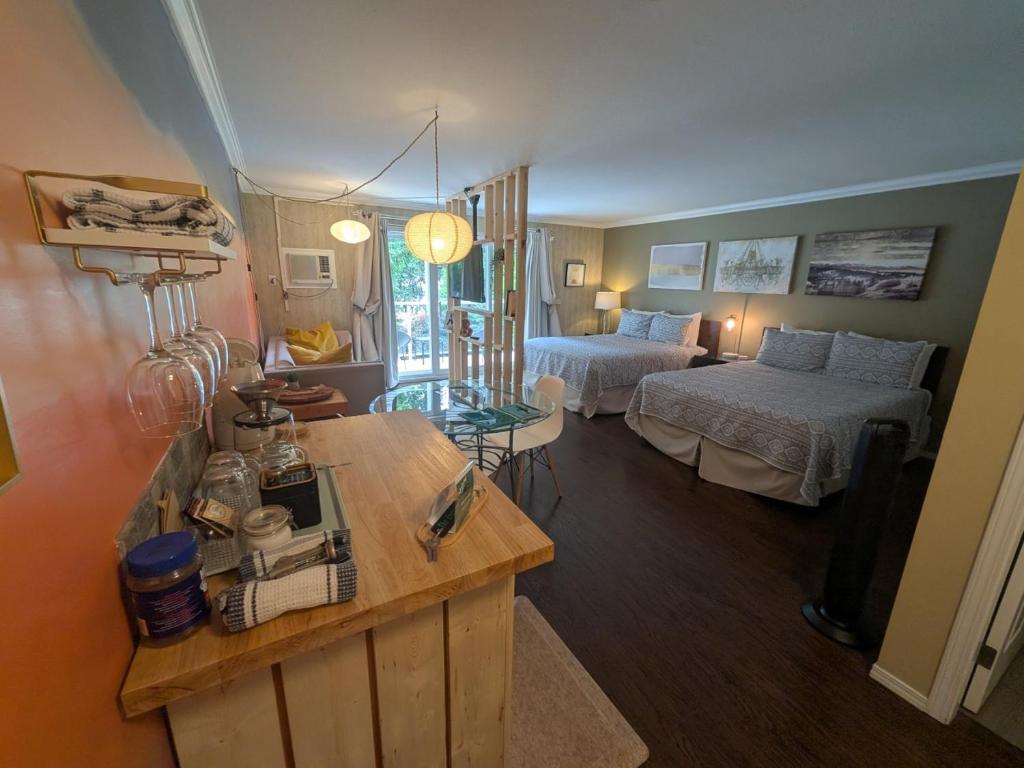a living room with two beds and a table in a room at Evergreen Bed & Breakfast in Hope