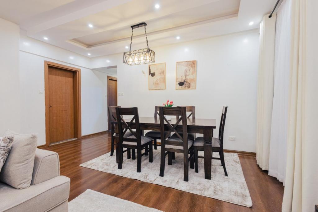 a dining room with a table and chairs at Rolling in Nairobi
