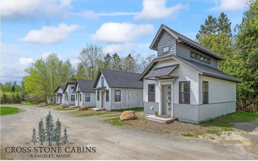 a row of houses with a driveway at The Summit Suite | Walk to Rangeley Lake • ATV & Sled Access in Rangeley