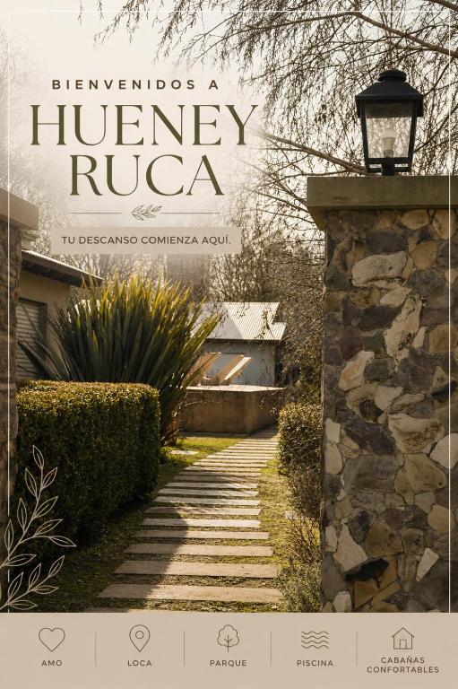 a book cover of the entrance to a house with a stone wall at Cabañas Hueney Ruca in Sierra de la Ventana