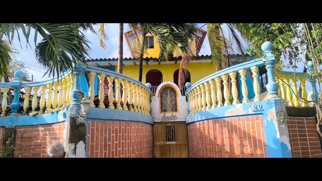 a house with a blue and yellow at Romervic vacational apartments in Juangriego