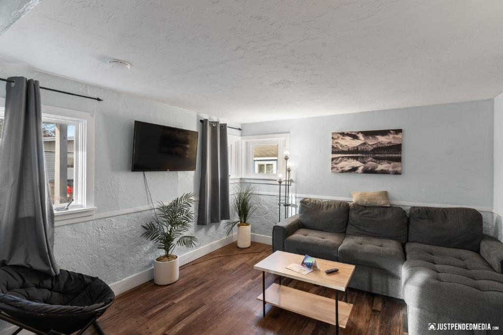 a living room with a couch and a table at Borealis Barnhouse - Slumber 7 in Anchorage