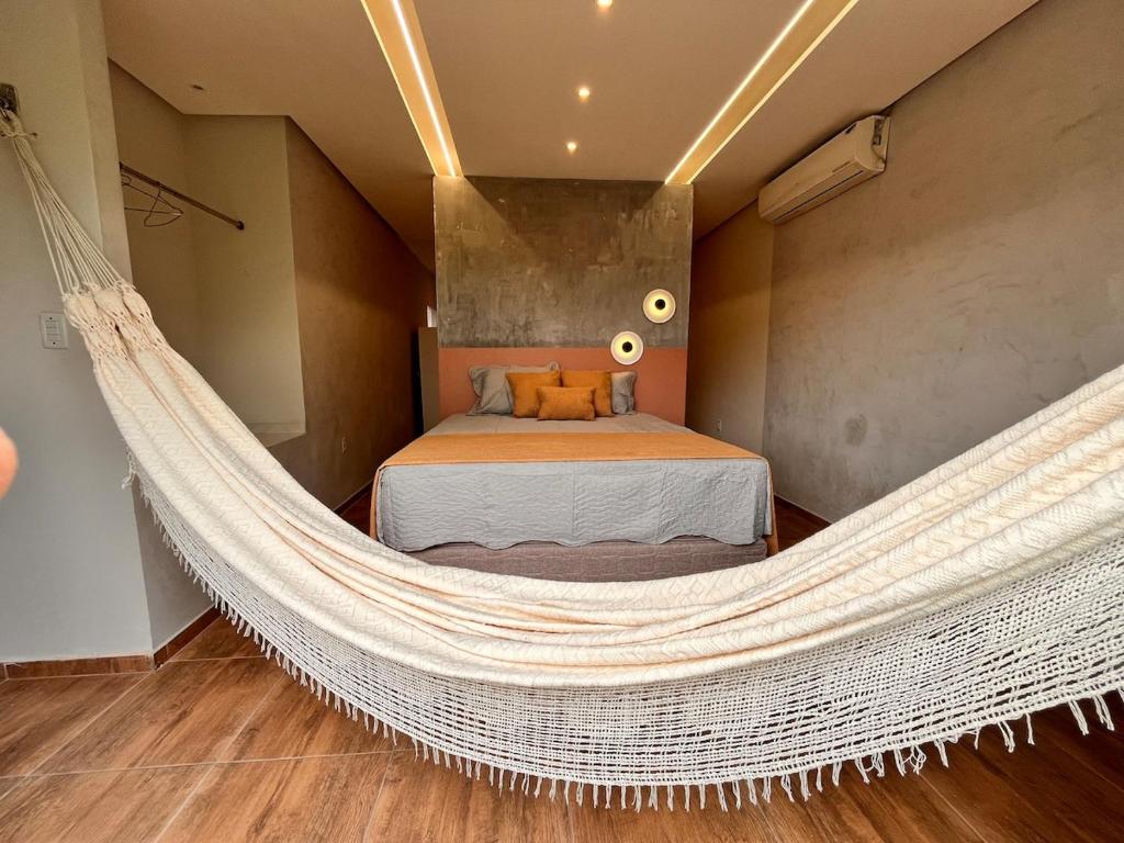 a hammock in a bedroom with a bed at Loft Moderno I in Mossoró