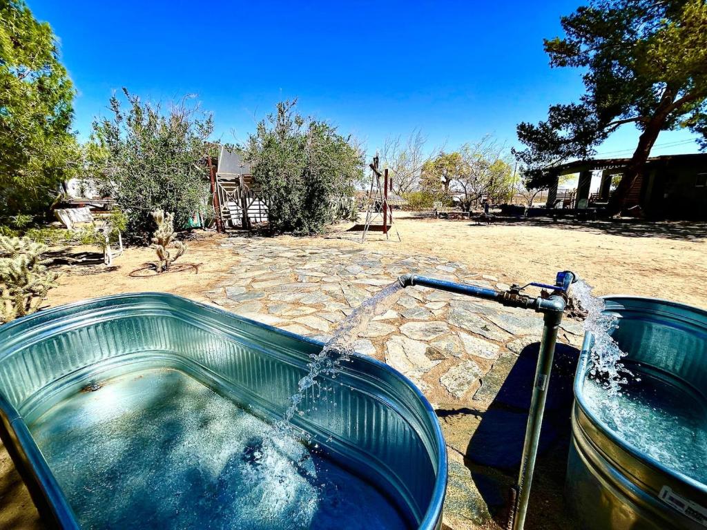 a pool of water pouring into a tub at Cowboy Tubs, Zen Labyinth, Views, Quiet Serenity in Joshua Tree