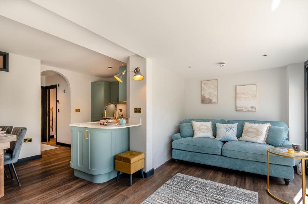 a living room with a blue couch and a table at 2 Bed in Tenby oc-b41402 in Tenby