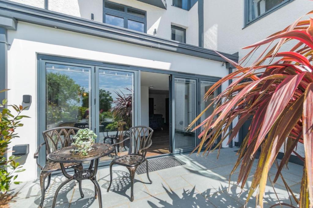 a patio with a table and chairs and some plants at 2 Bed in Tenby oc-b41399 in Tenby