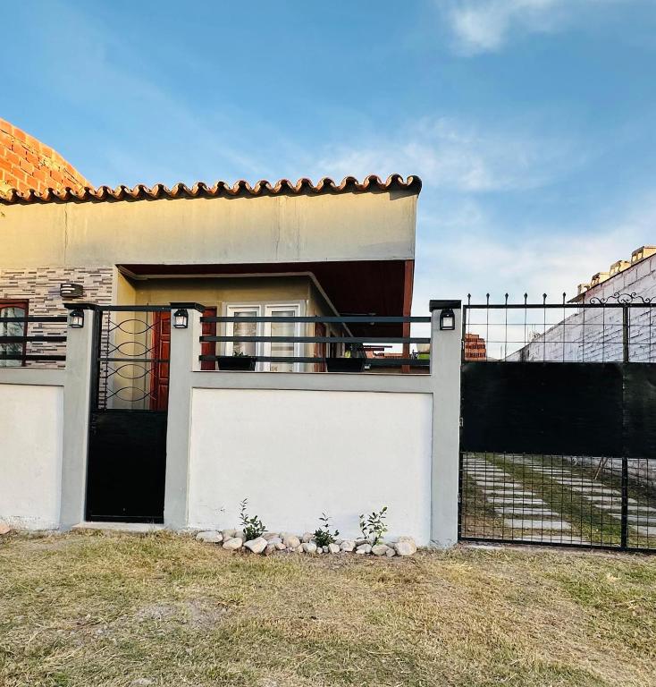a white house with a gate and a fence at Sueño de Chicoana in Chicoana