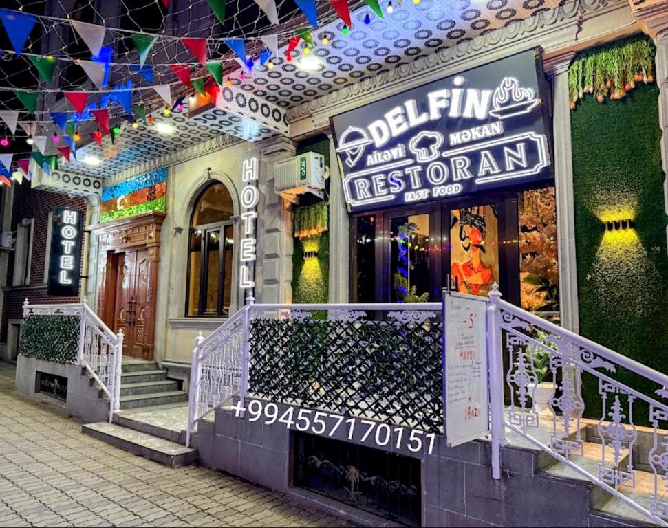 a store with a sign on the front of a building at Delfin Hotel Restaurant Spa Ailevi in Ganja