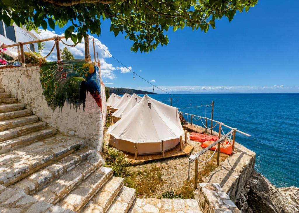 a group of tents sitting next to the water at Albania Glamping in Himare