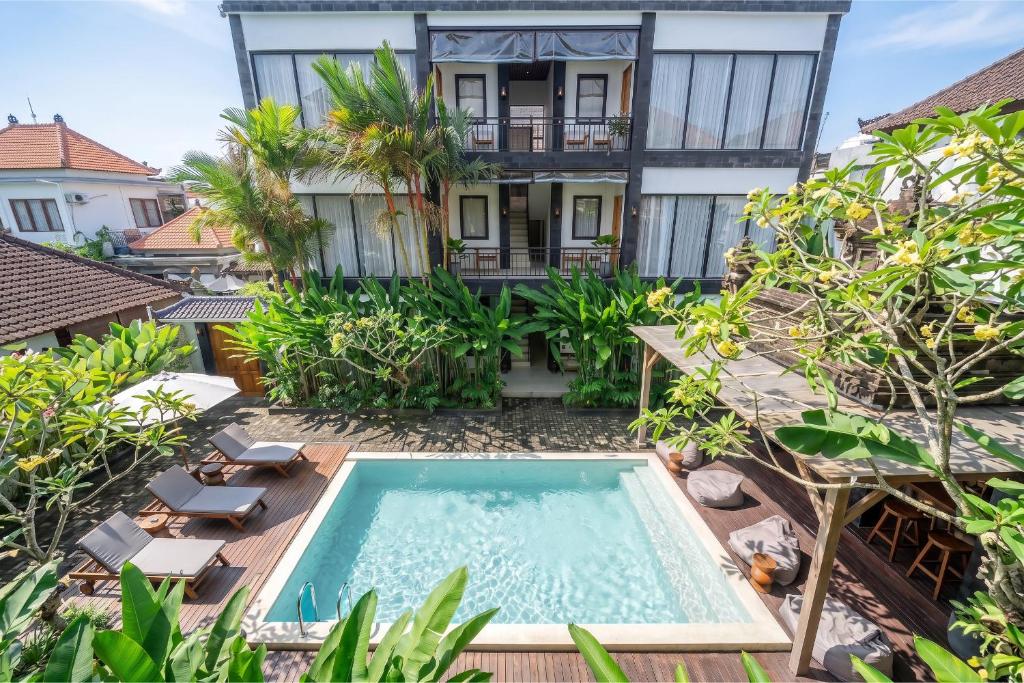 an image of a villa with a swimming pool and a house at Sebelas Apartments by EVDEkimi - Modern Stay with Pool near Dining & Shops in Ubud