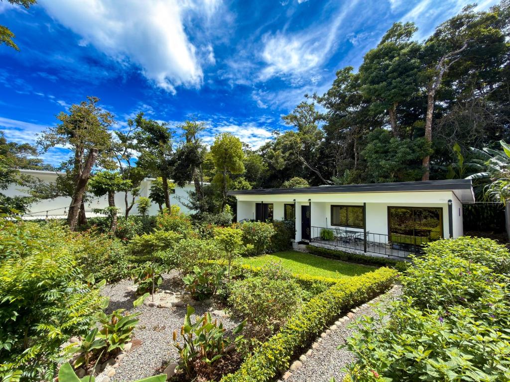 a house with a garden in front of it at Monteverde Magic Mountain Lodge in Monteverde Costa Rica