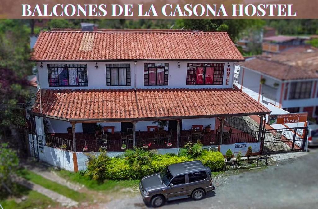 a black truck parked in front of a house at Balcones de la Casona in Guatapé