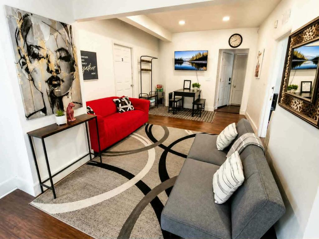 a living room with a red couch and a table at The Victorian House in Buffalo