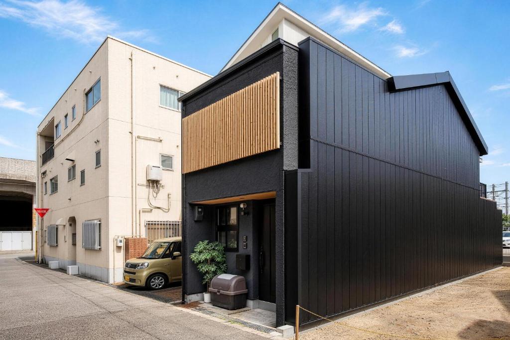 a black house with a black facade at New! 3A Home 難波&道頓堀直通 2LDK一棟貸切 最大4名 in Osaka