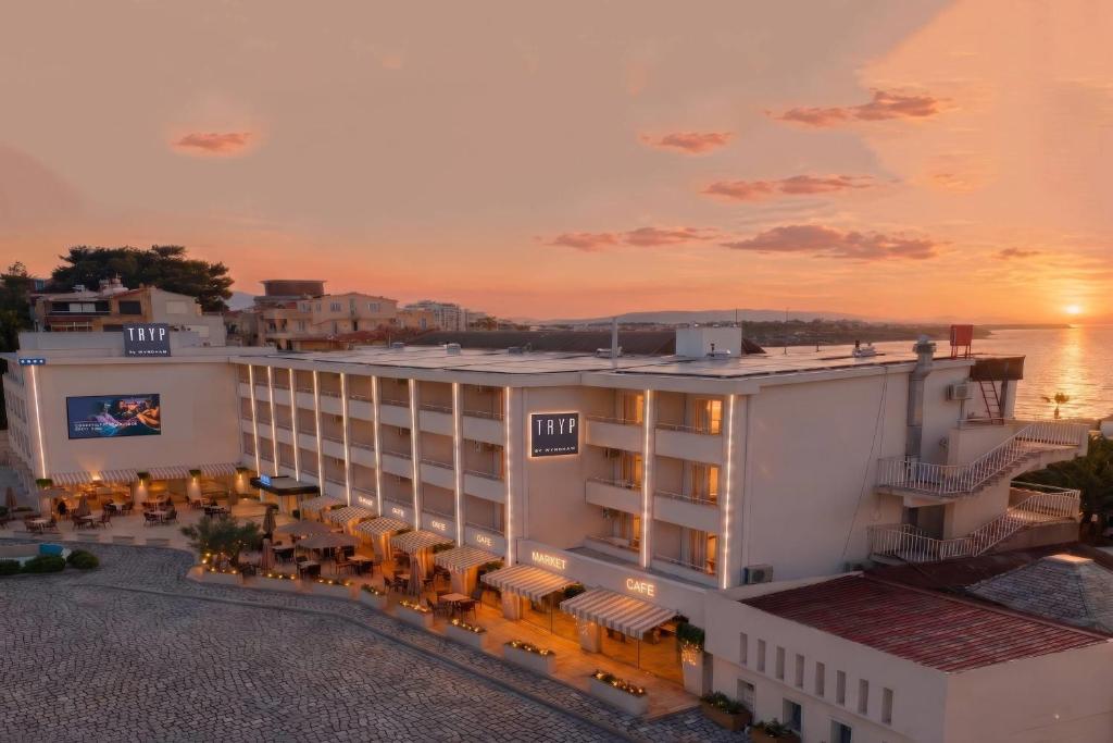 a rendering of a hotel with a sunset in the background at TRYP by Wyndham Didim in Didim