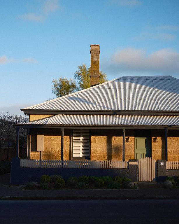 a house with a tin roof with a fence at Raffah House in Oatlands
