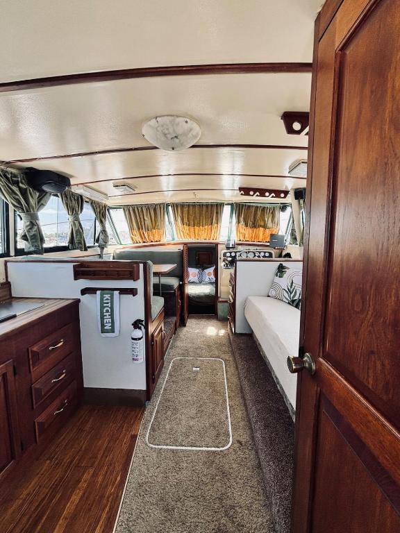 an interior of an rv with a bed and a kitchen at Buffalo's River Den II - Easy Rider in Buffalo