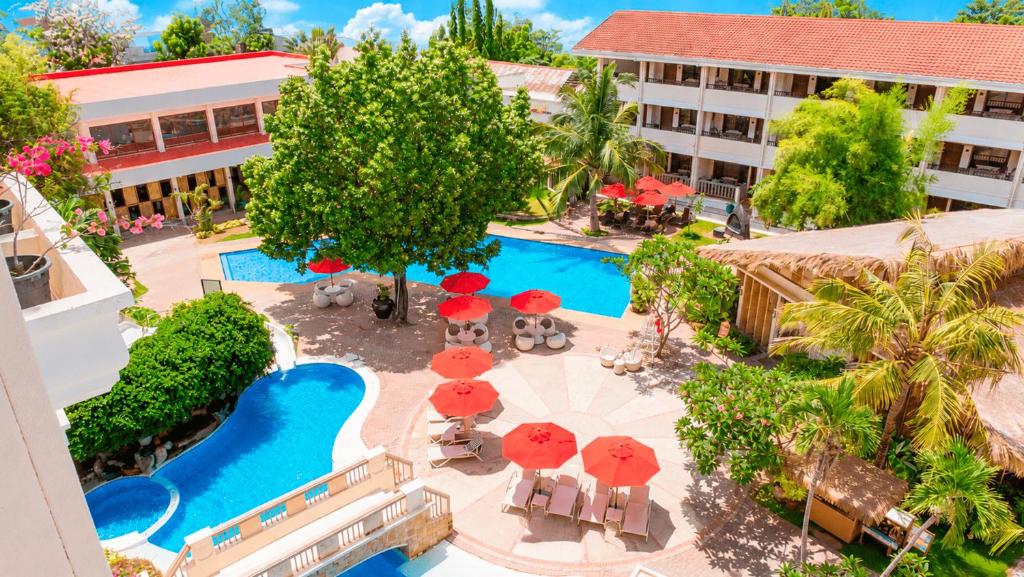 an overhead view of a resort with a pool and umbrellas at Costabella Tropical Beach Hotel in Mactan