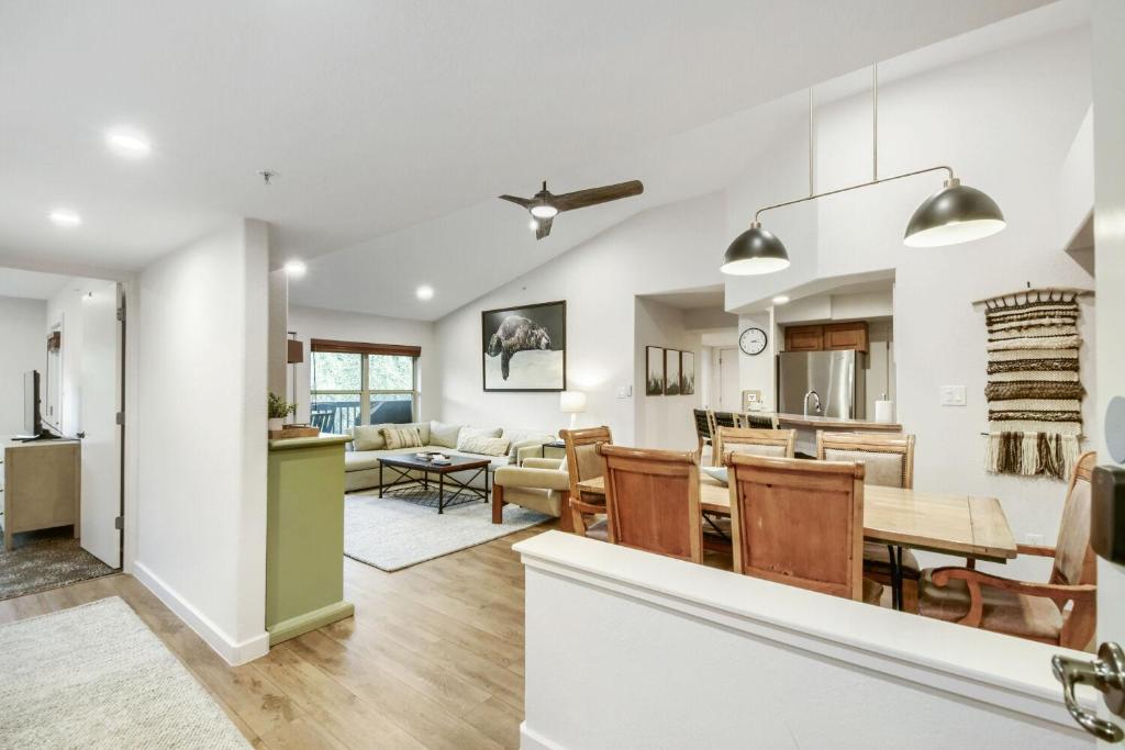 an open living room and dining room with a dining table and a kitchen at River Pines A303 condo in Edwards