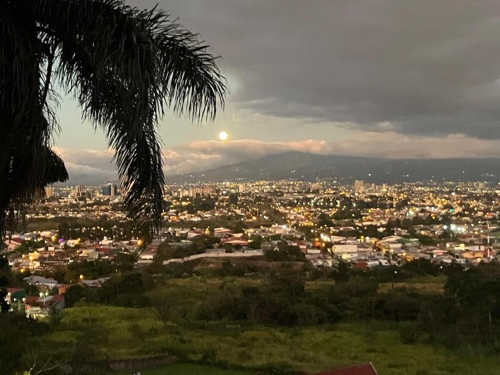 a view of a city with the moon in the sky at Casa Roraima in San Antonio