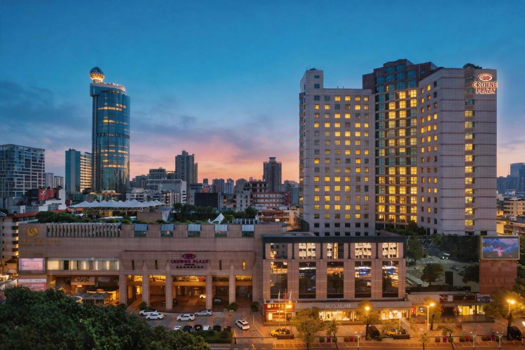 a city skyline with tall buildings at night at Crowne Plaza Foshan by IHG in Foshan
