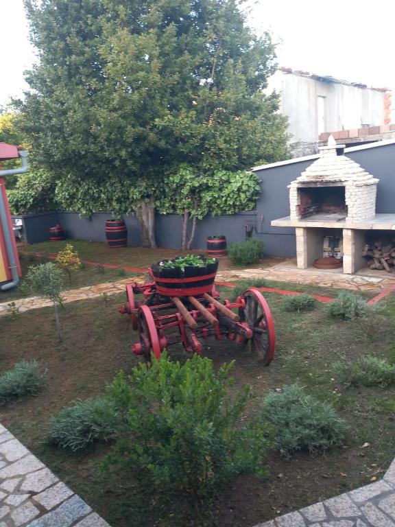 a tractor sitting in a yard with a planter on it at Modern Villa with Garden & Terrace, 13 min to Pula Arena in Pula