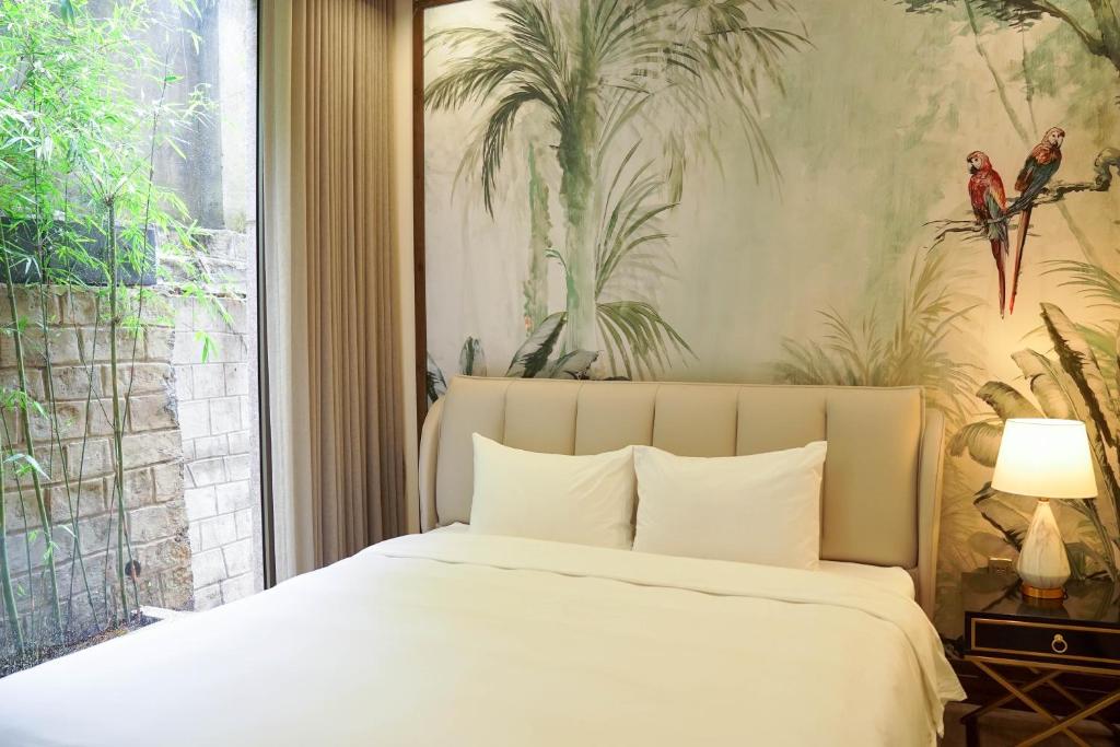 a bedroom with a bed and a large window at Samten Hills Villa Dalat in Xuan An