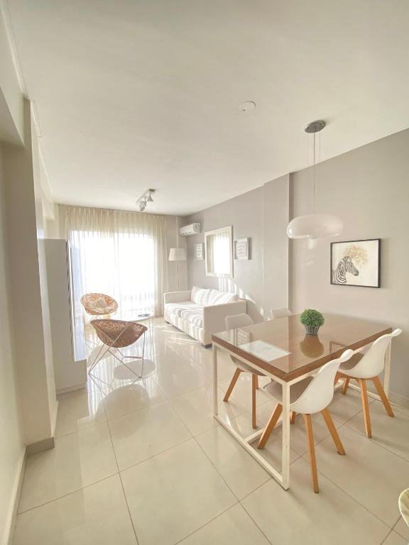 a living room with a table and a couch at 9 de Julio Park Suites in San Miguel de Tucumán