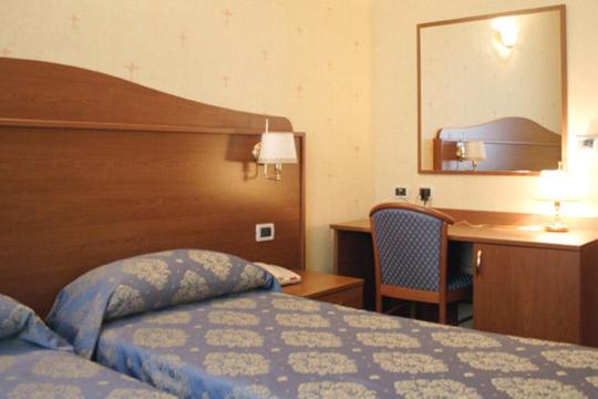 Ліжко або ліжка в номері Hotel Rigolfo