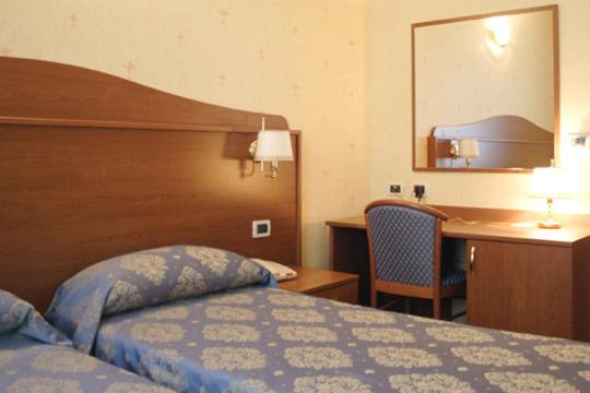 Postel nebo postele na pokoji v ubytování Hotel Rigolfo